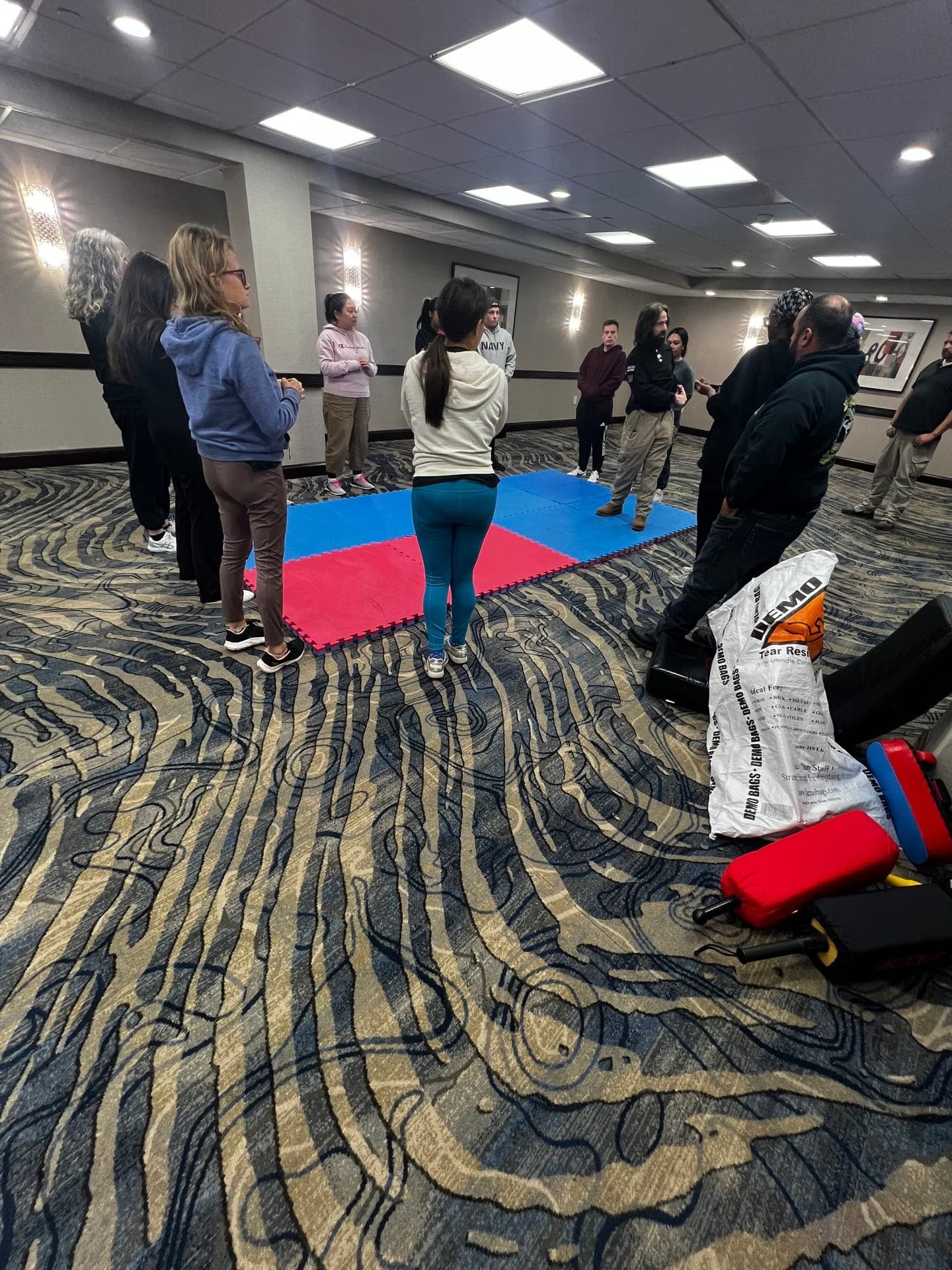 Self-defense training class — group exercise on mats