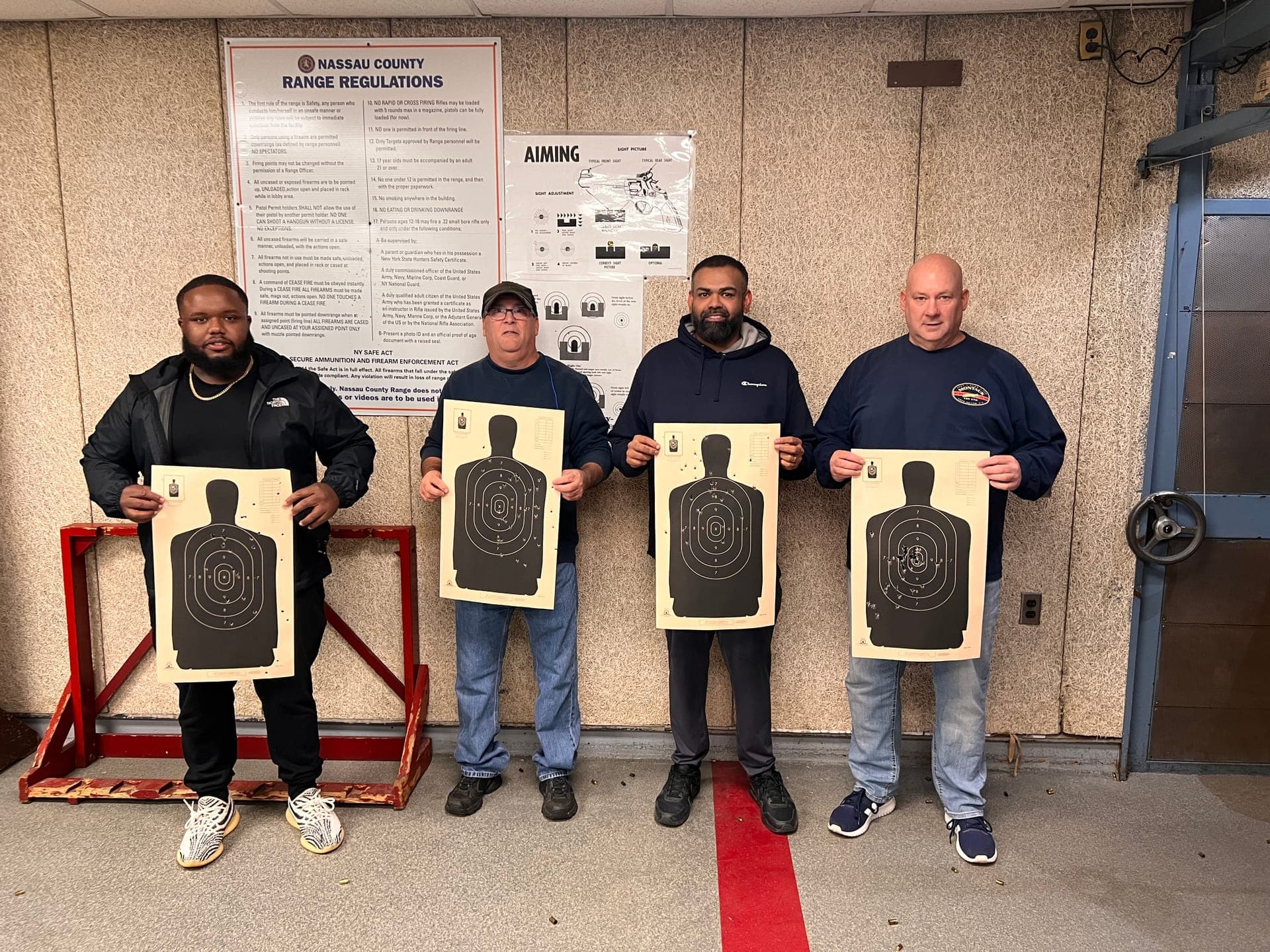 Students holding targets at Nassau County range